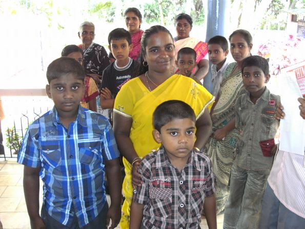 Een gelukkige moeder (weduwe) met haar kinderen op onze "Orphans Support" ontmoetingdag.